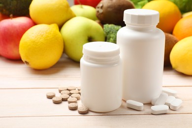 Photo of Dietary supplements. Blank white bottles and different pills near food products on light wooden table