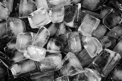 Many ice cubes on black background, top view