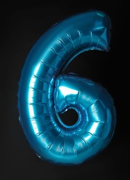 Photo of Blue number six balloon on black background