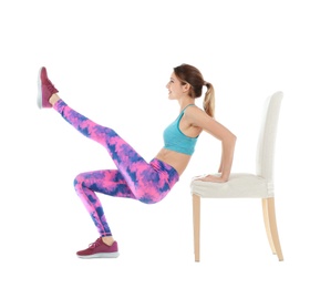 Photo of Young woman exercising with chair on white background. Home fitness