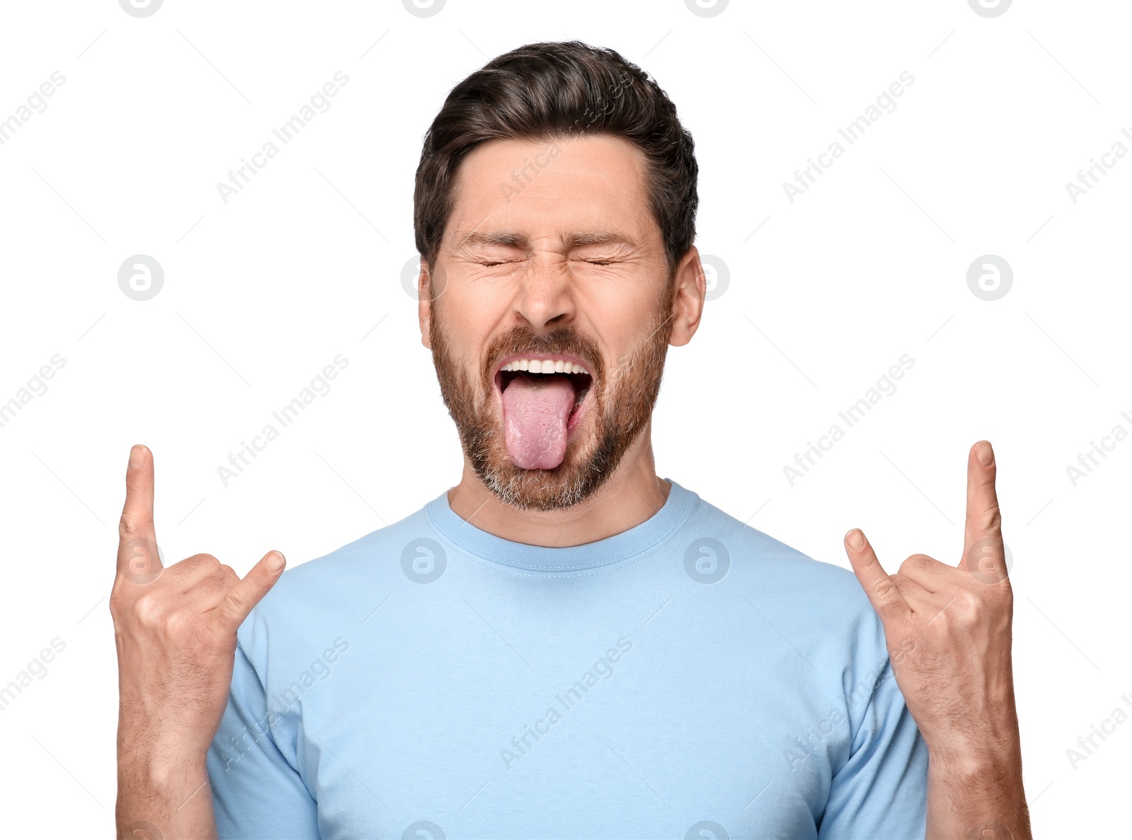 Photo of Man showing his tongue and rock gesture on white background