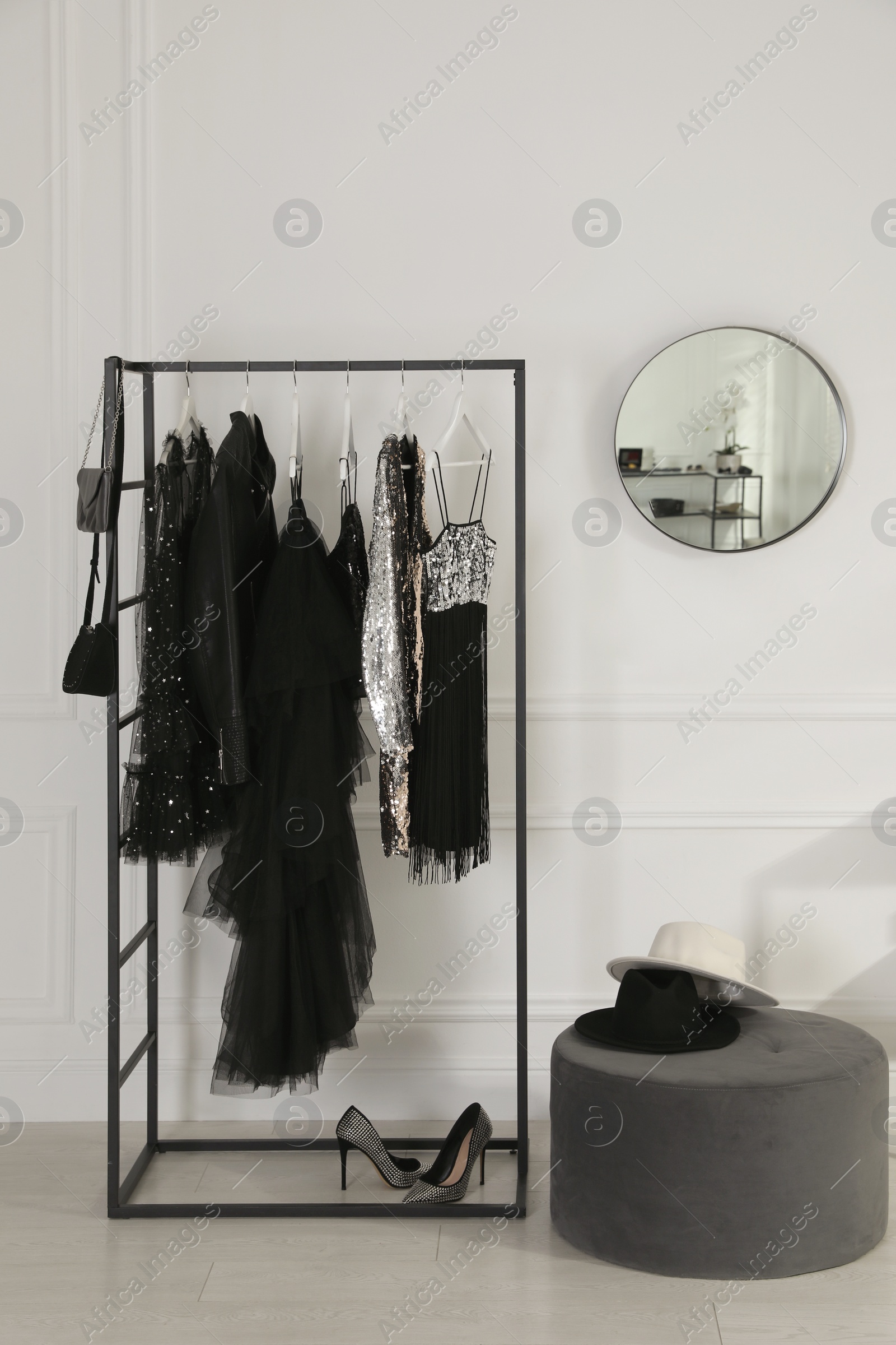 Photo of Stylish dressing room interior with trendy clothes, shoes and accessories