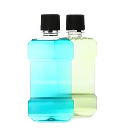 Bottles with mouthwash for teeth care on white background