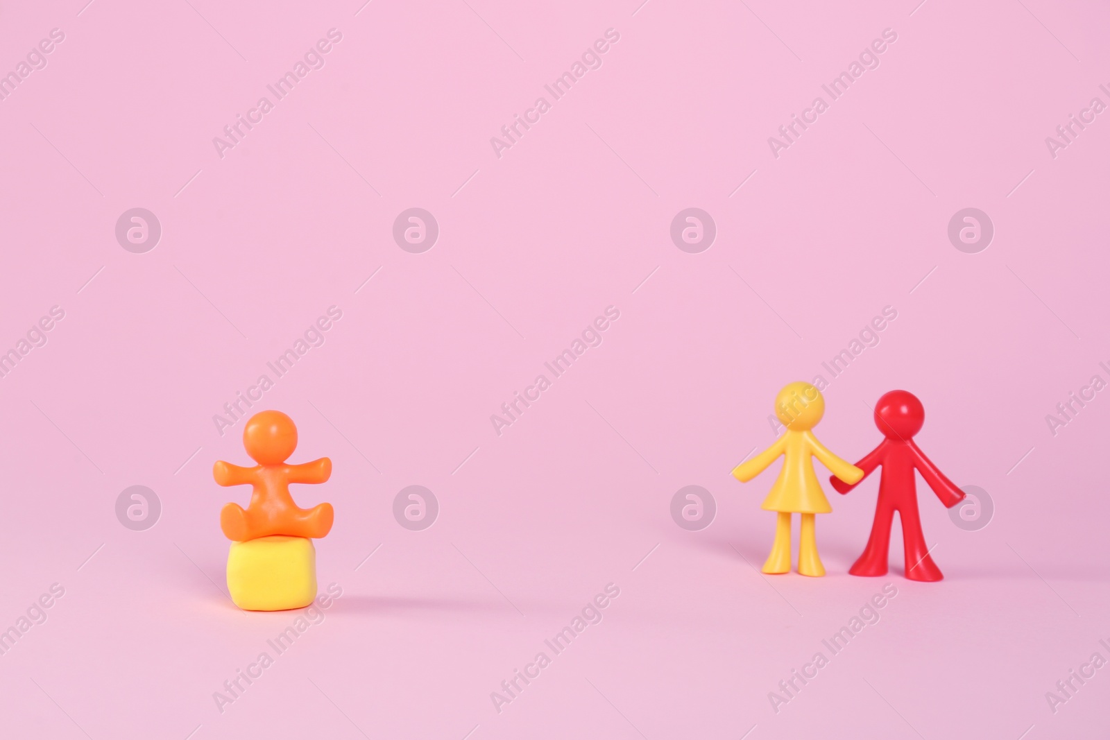 Photo of MYKOLAIV, UKRAINE - JANUARY 04, 2022: Colorful human figures on pink background, space for text. Surrogacy concept