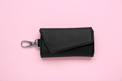 Photo of Stylish leather keys holder on pink background, top view