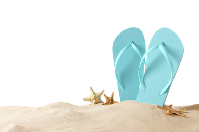 Photo of Light blue flip flops and starfishes on sand against white background, space for text. Beach objects