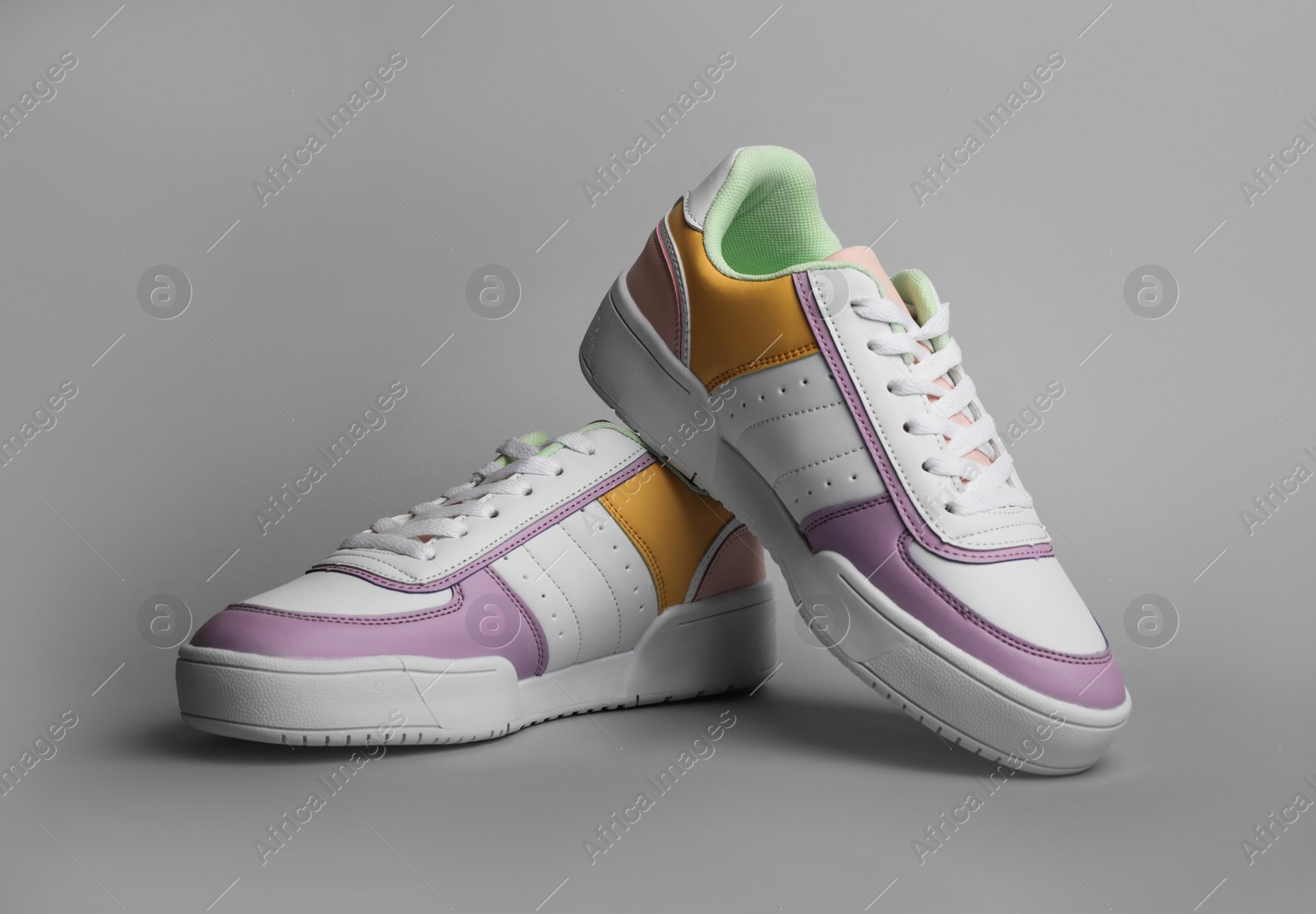 Photo of Pair of comfortable sports shoes on grey background