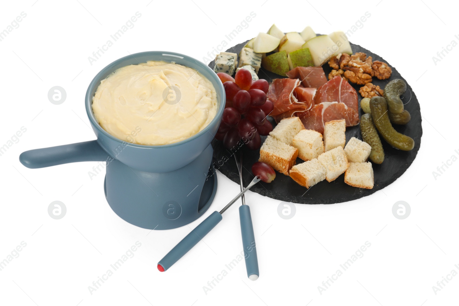 Photo of Fondue with tasty melted cheese, forks and different snacks isolated on white