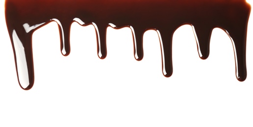 Photo of Delicious melted chocolate flowing on white background