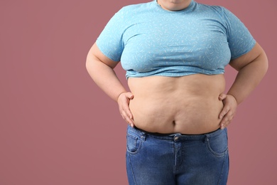 Overweight woman on color background