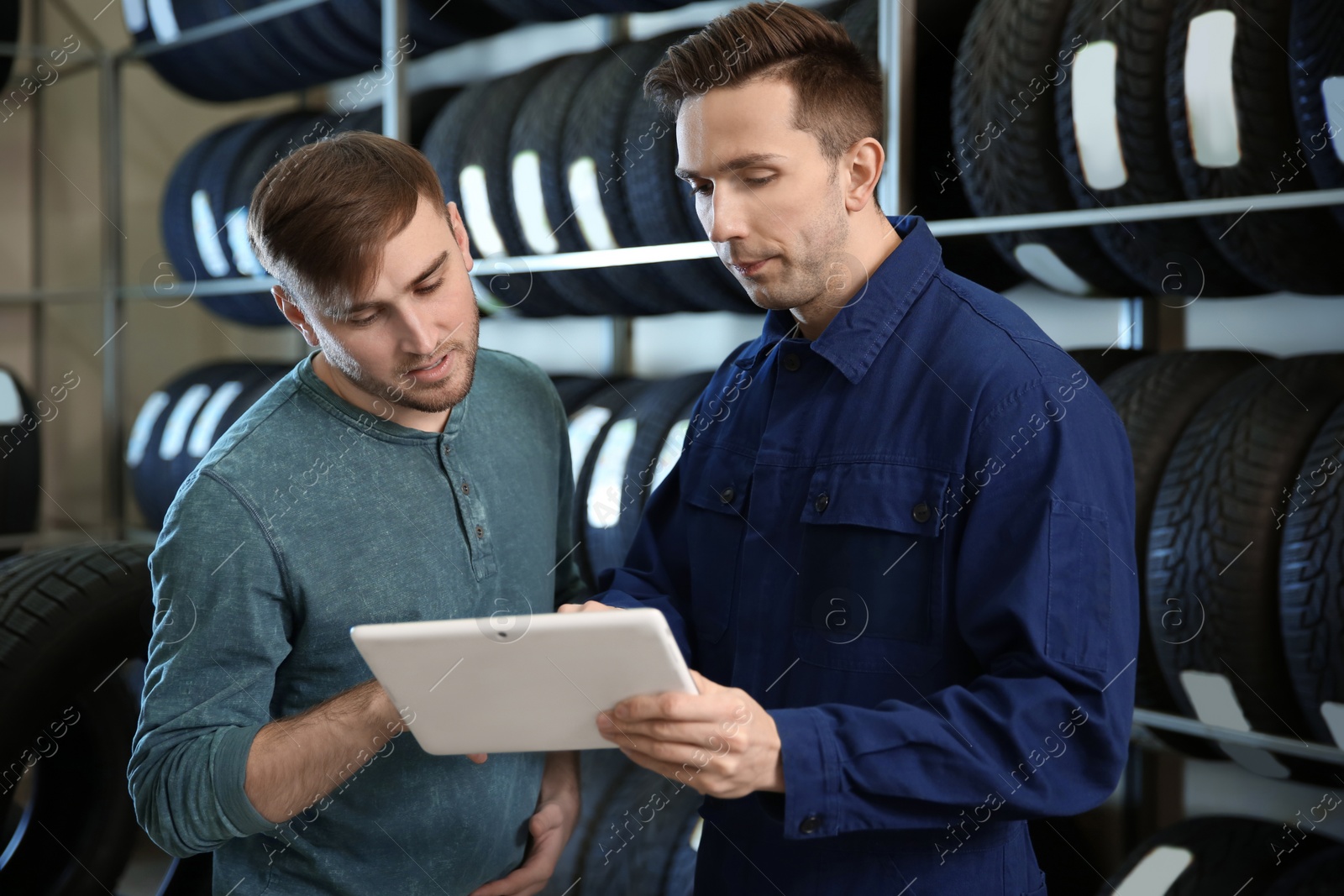 Photo of Service center consultant helping customer to choose tire in store