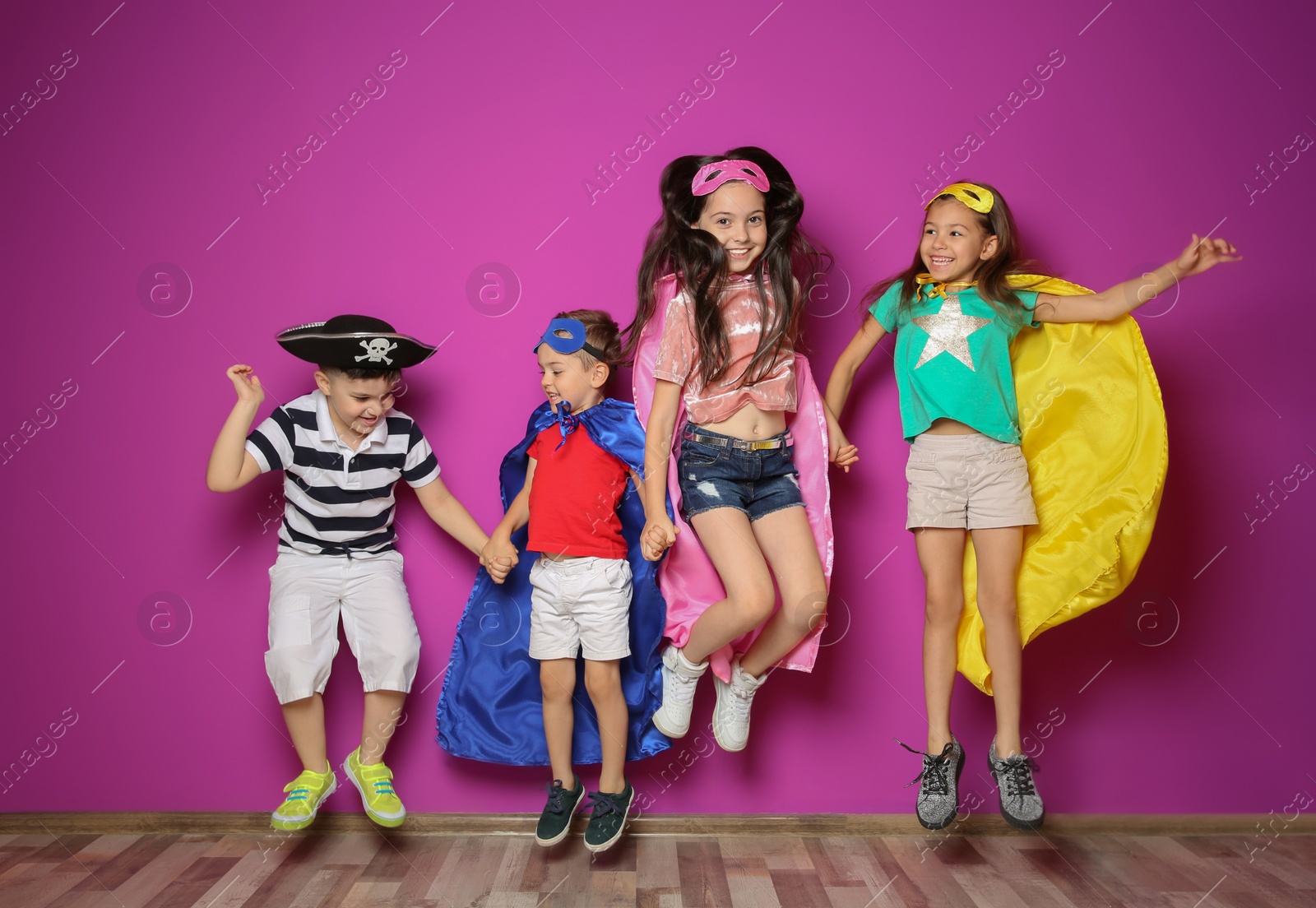 Photo of Playful little children in cute costumes indoors