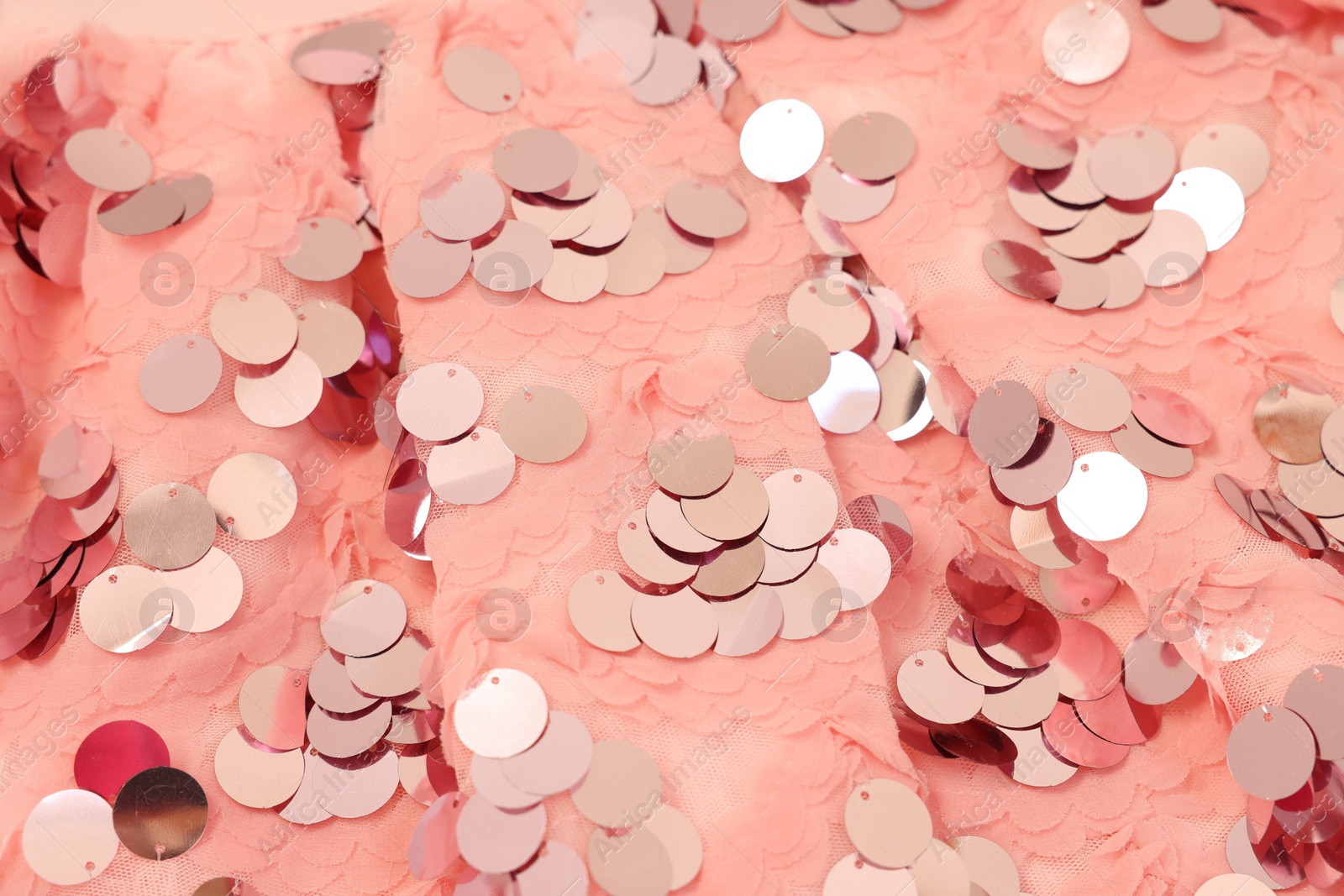 Photo of Texture of stylish pink carnival dress with sequins as background, closeup