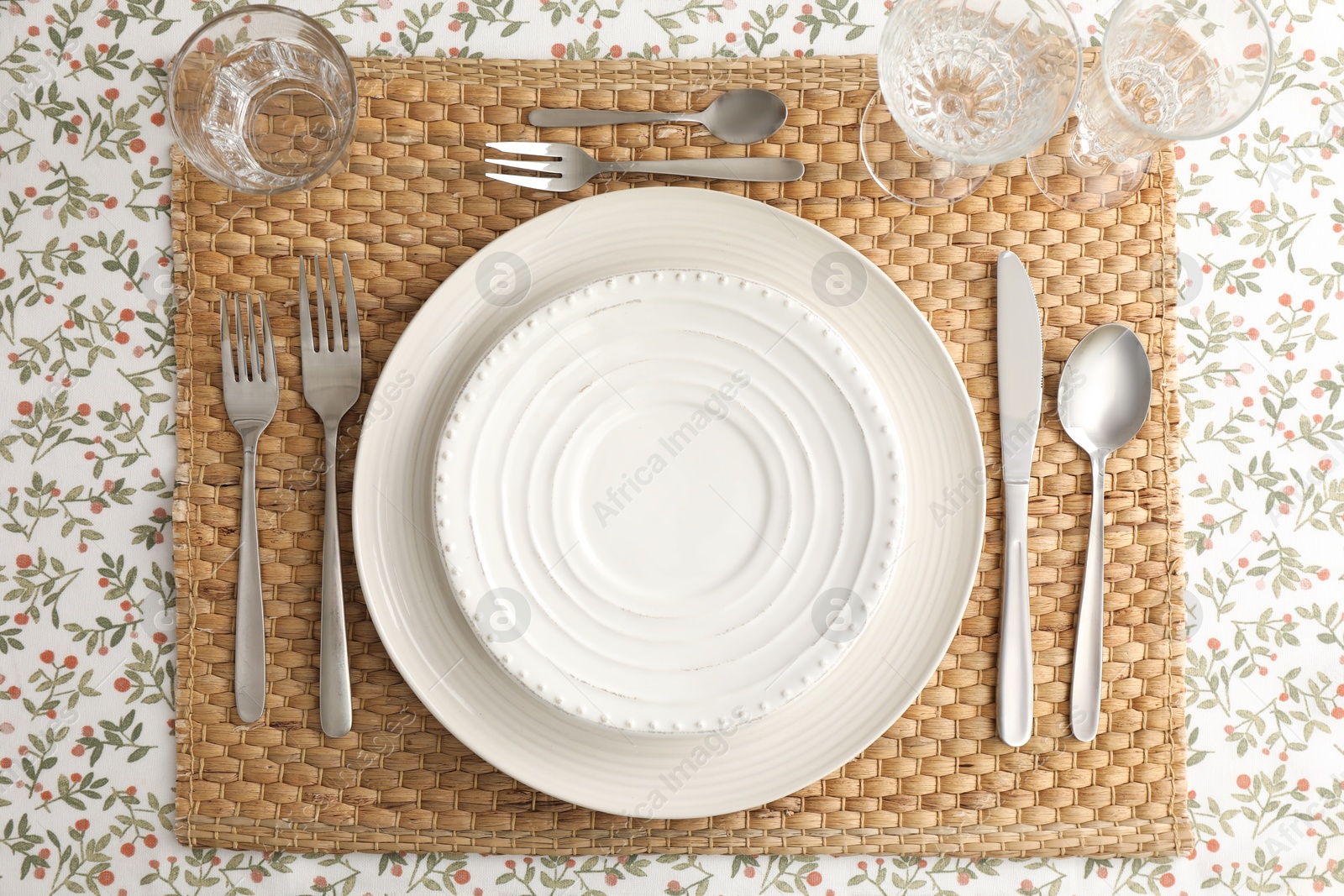 Photo of Stylish setting with cutlery, plates and glasses on table, top view