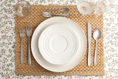 Stylish setting with cutlery, plates and glasses on table, top view