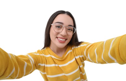 Smiling young woman taking selfie on white background