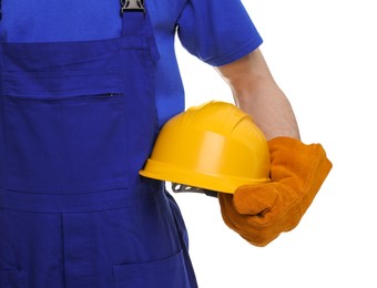 Young man holding yellow hardhat on white background, closeup. Safety equipment