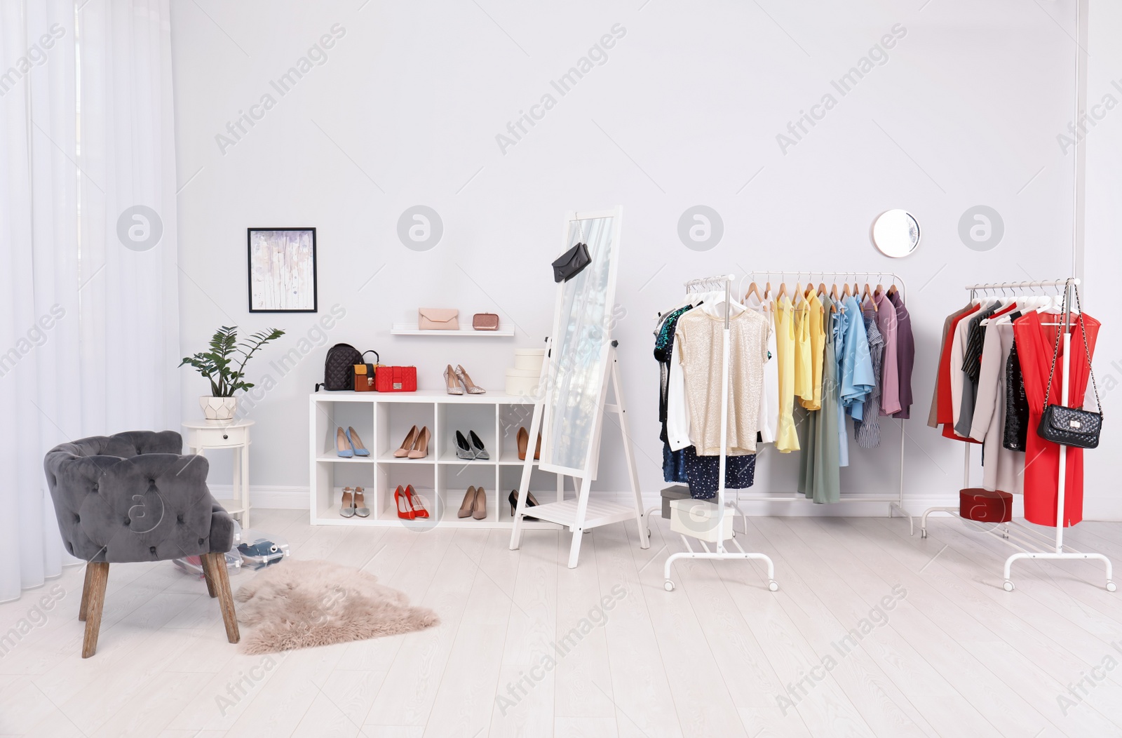 Photo of Light room interior with stylish clothes and shoes