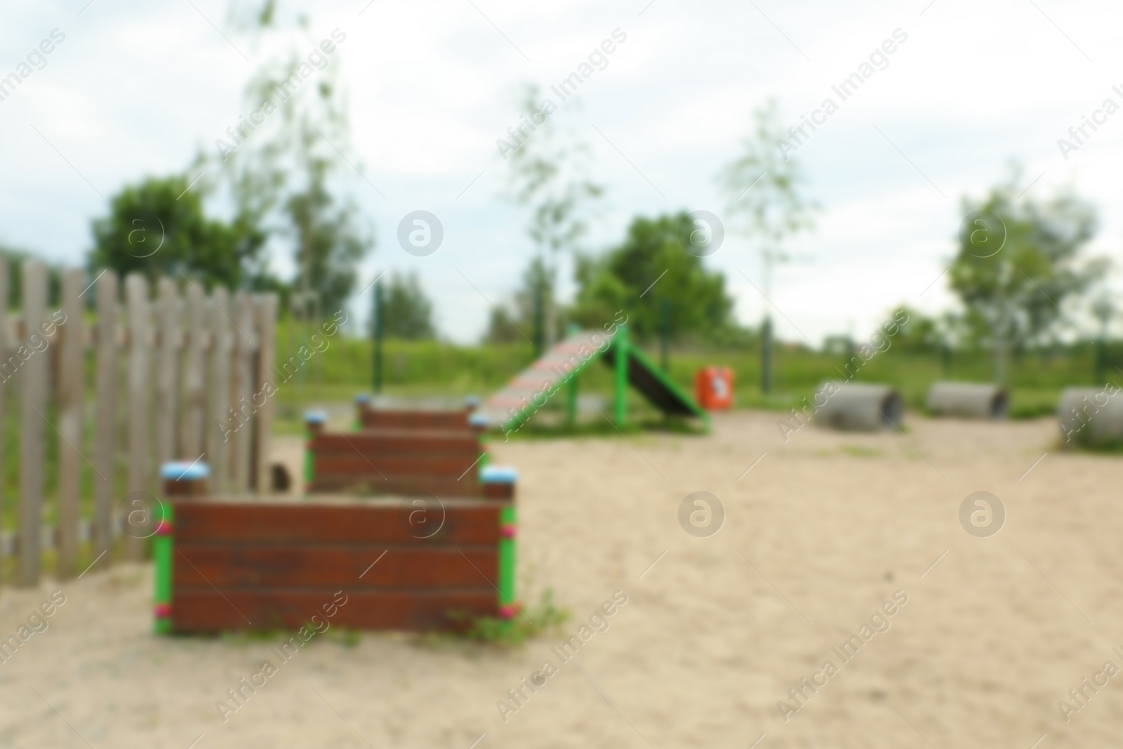 Photo of Wooden rover jump over, king of hill and doggie crawls on animal training area outdoors, blurred view