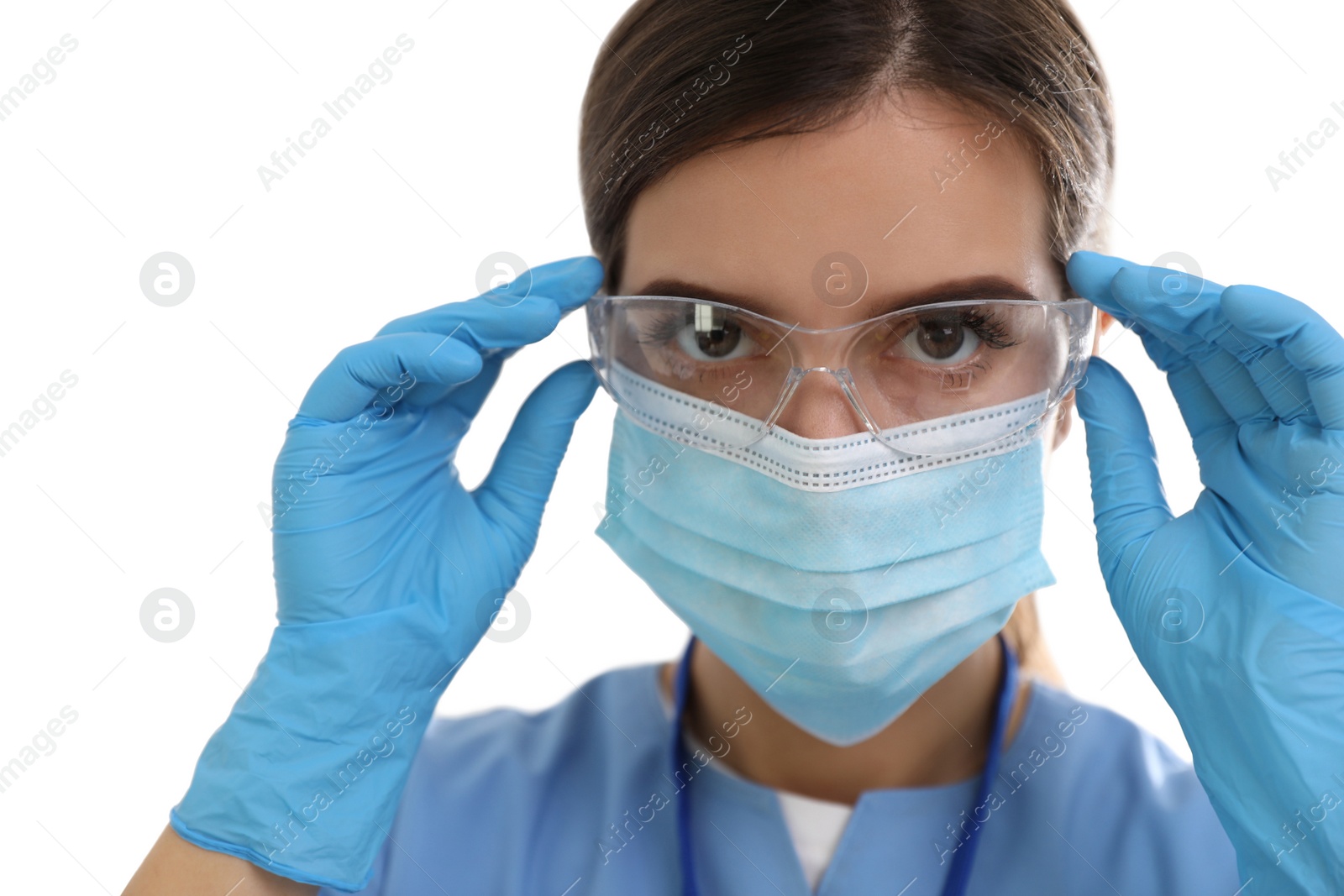 Photo of Doctor in medical gloves and protective mask putting on glasses against white background, closeup
