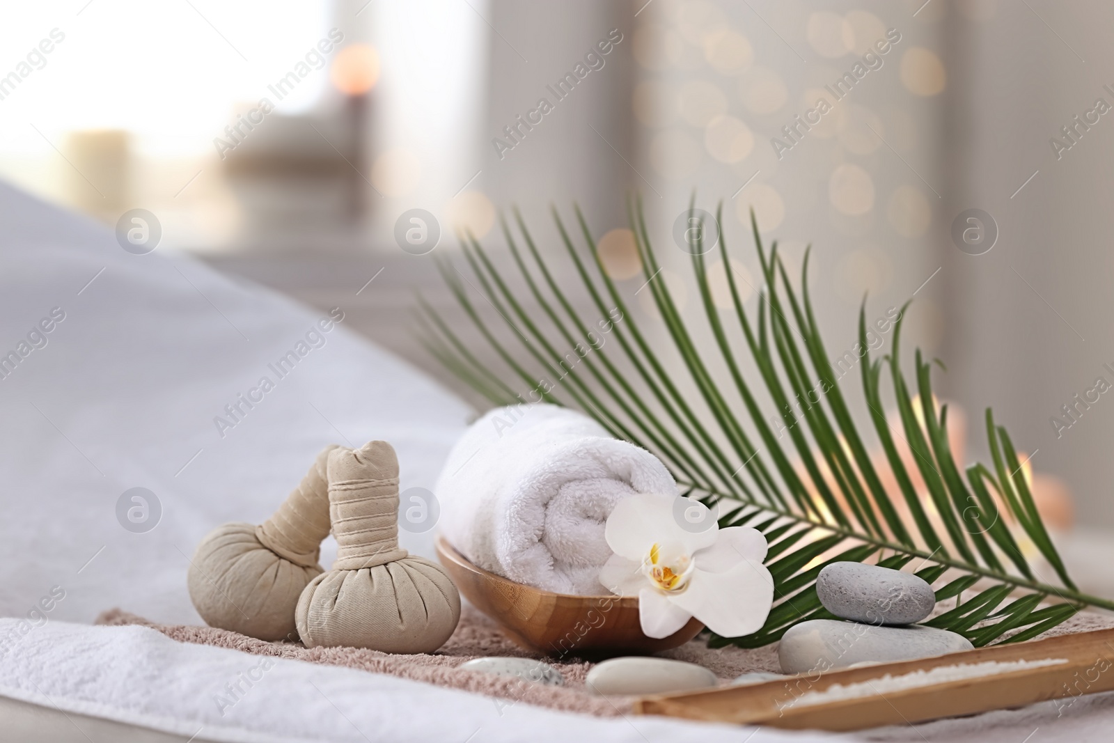 Photo of Beautiful spa composition on massage table in wellness center