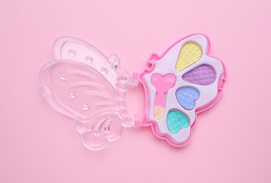 Photo of Decorative cosmetics for kids. Eye shadow palette on pink background, top view