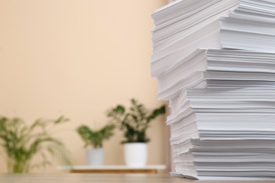 Stack of paper sheets on wooden table indoors. Space for text