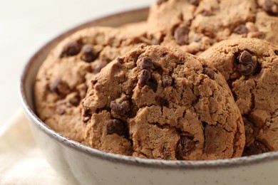 Photo of Delicious chocolate chip cookies in bowl, closeup