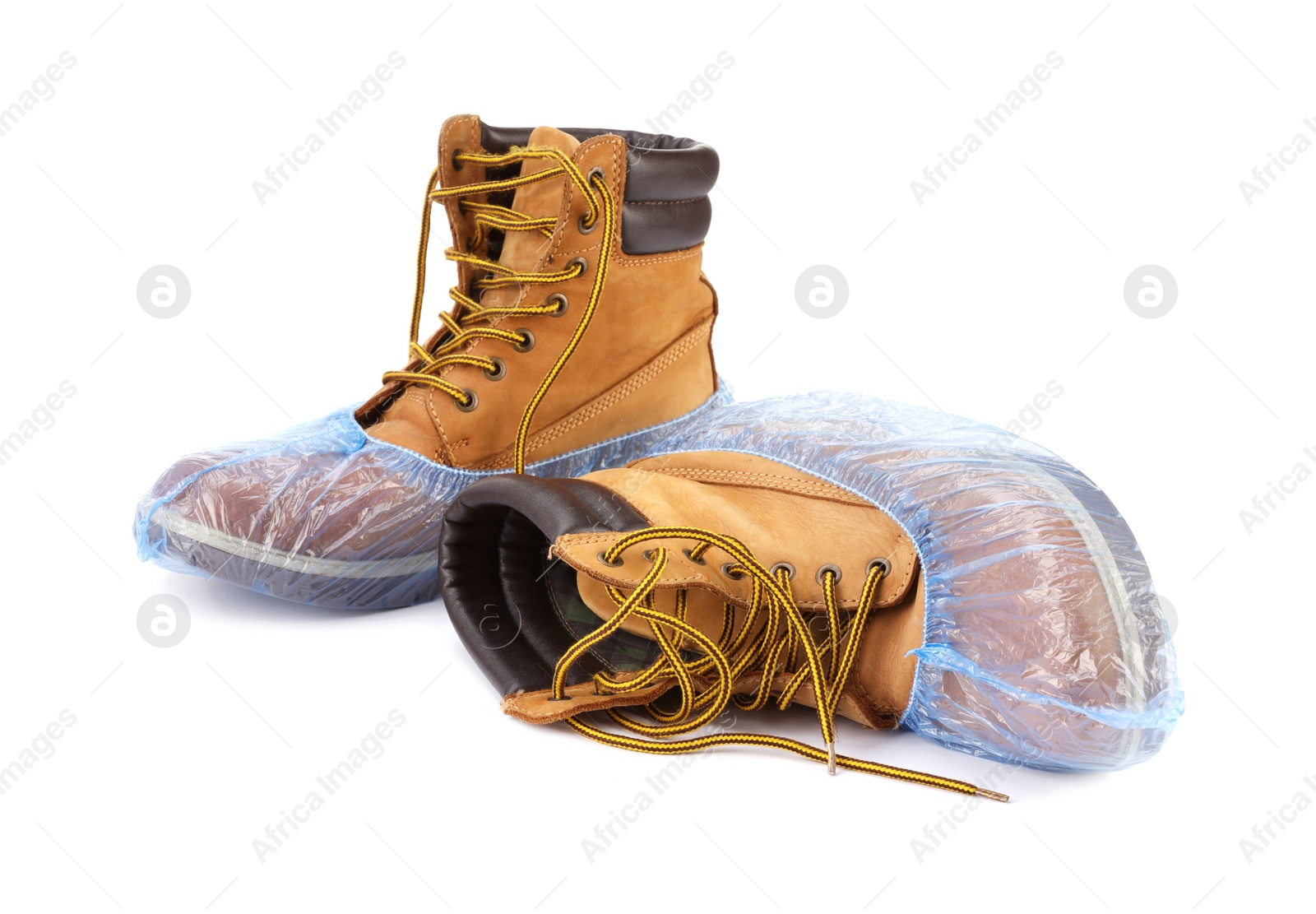 Photo of Boots in blue shoe covers isolated on white