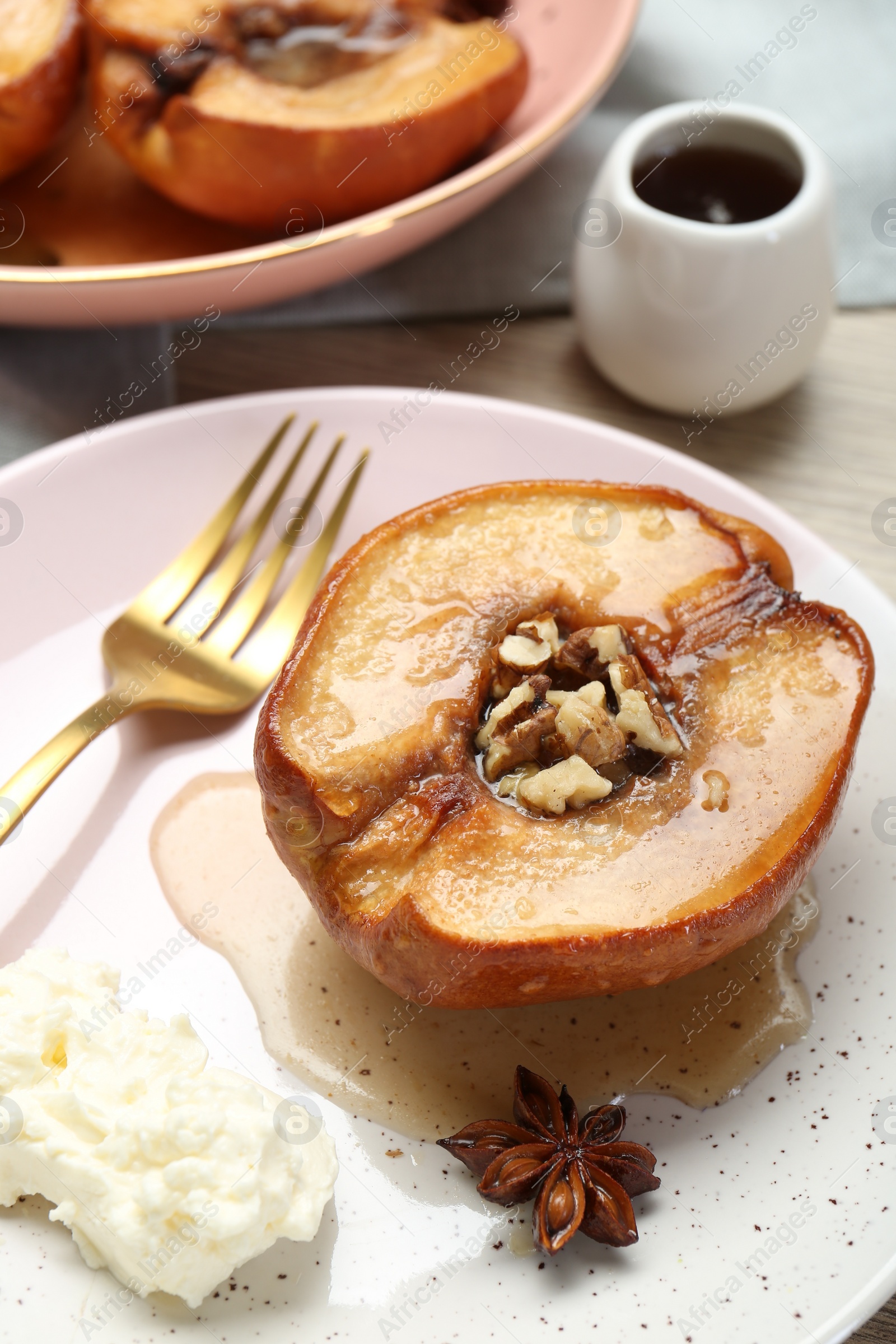 Photo of Delicious quince baked with honey and walnuts on table, closeup