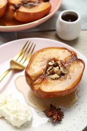 Photo of Delicious quince baked with honey and walnuts on table, closeup