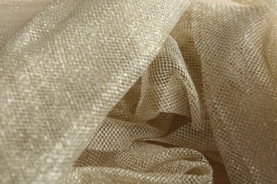 Texture of golden net fabric as background, closeup