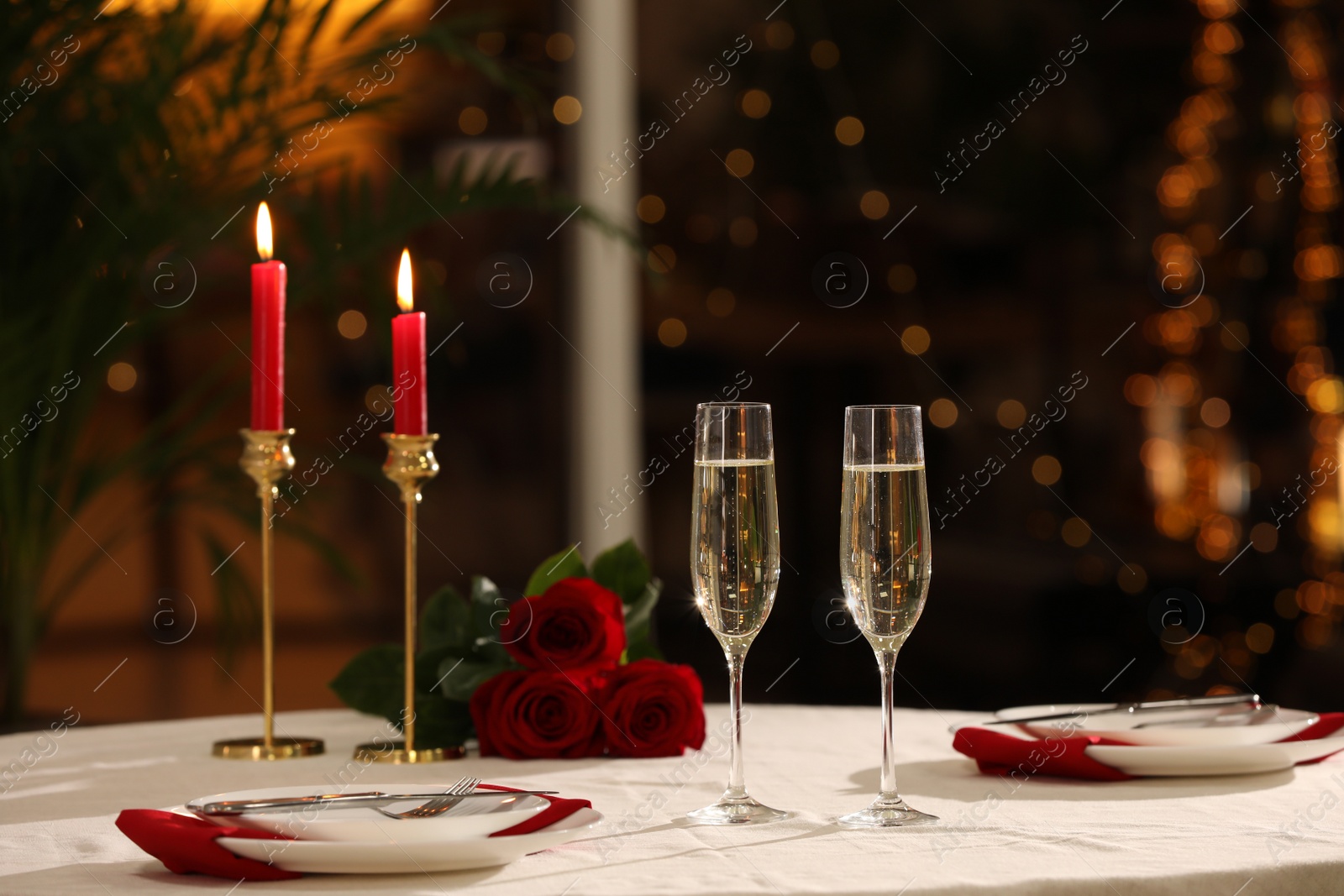 Photo of Romantic dinner table setting with glasses of champagne in restaurant