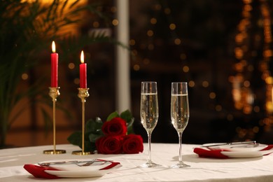 Romantic dinner table setting with glasses of champagne in restaurant