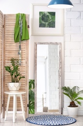 Photo of Modern interior with large stylish mirror with tropical plants
