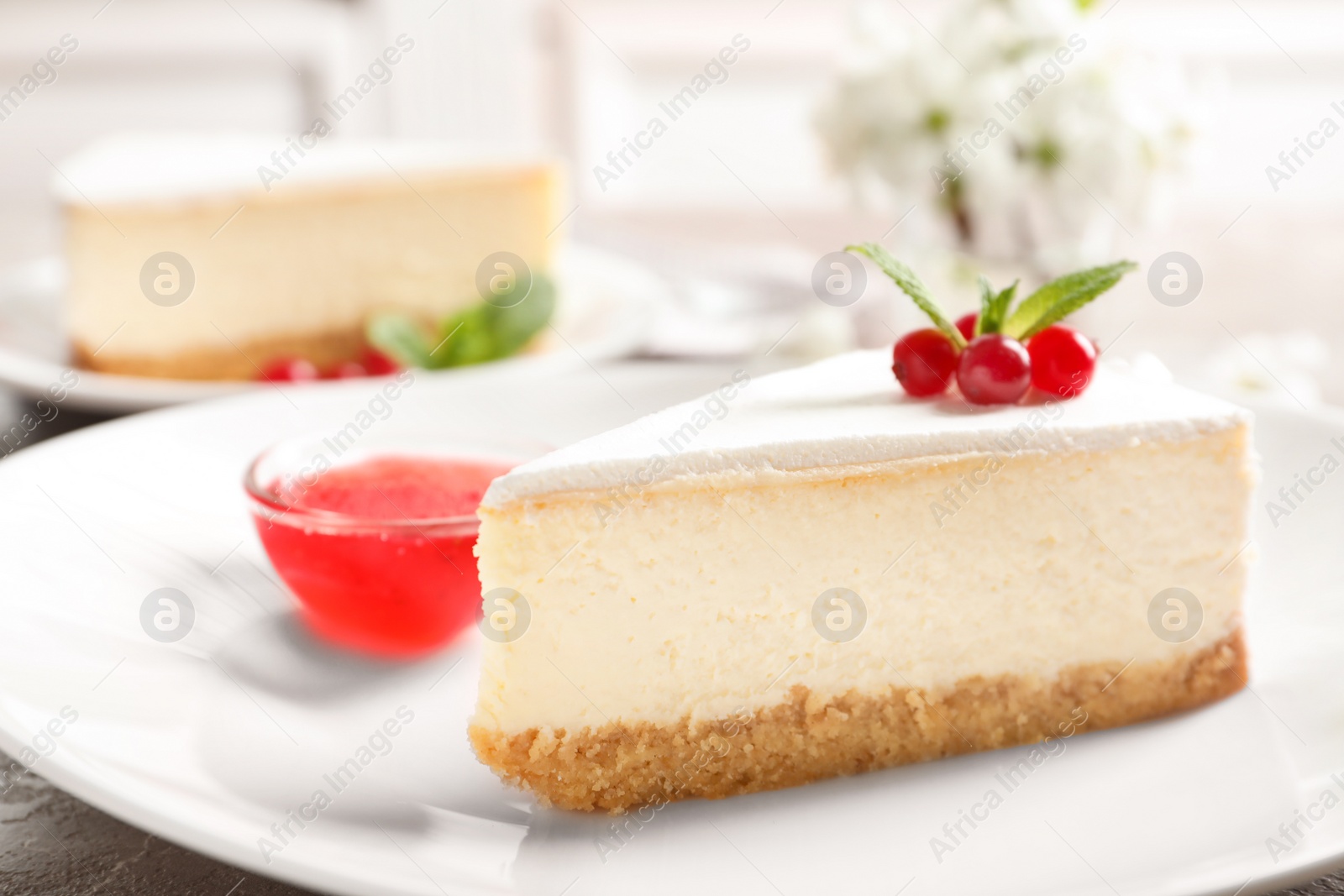 Photo of Delicious cheesecake served with sweet jam on plate