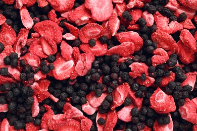 Photo of Closeupfreeze dried blueberries and strawberries as background, top view