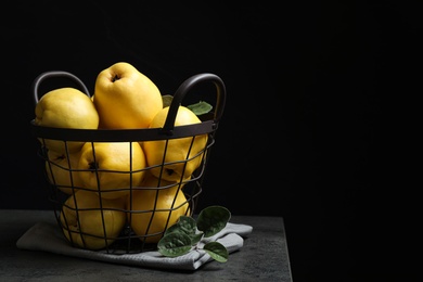 Photo of Fresh ripe organic quinces on grey table. Space for text