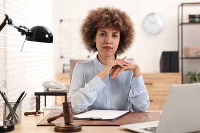 Notary with clipboard and pen at workplace in office