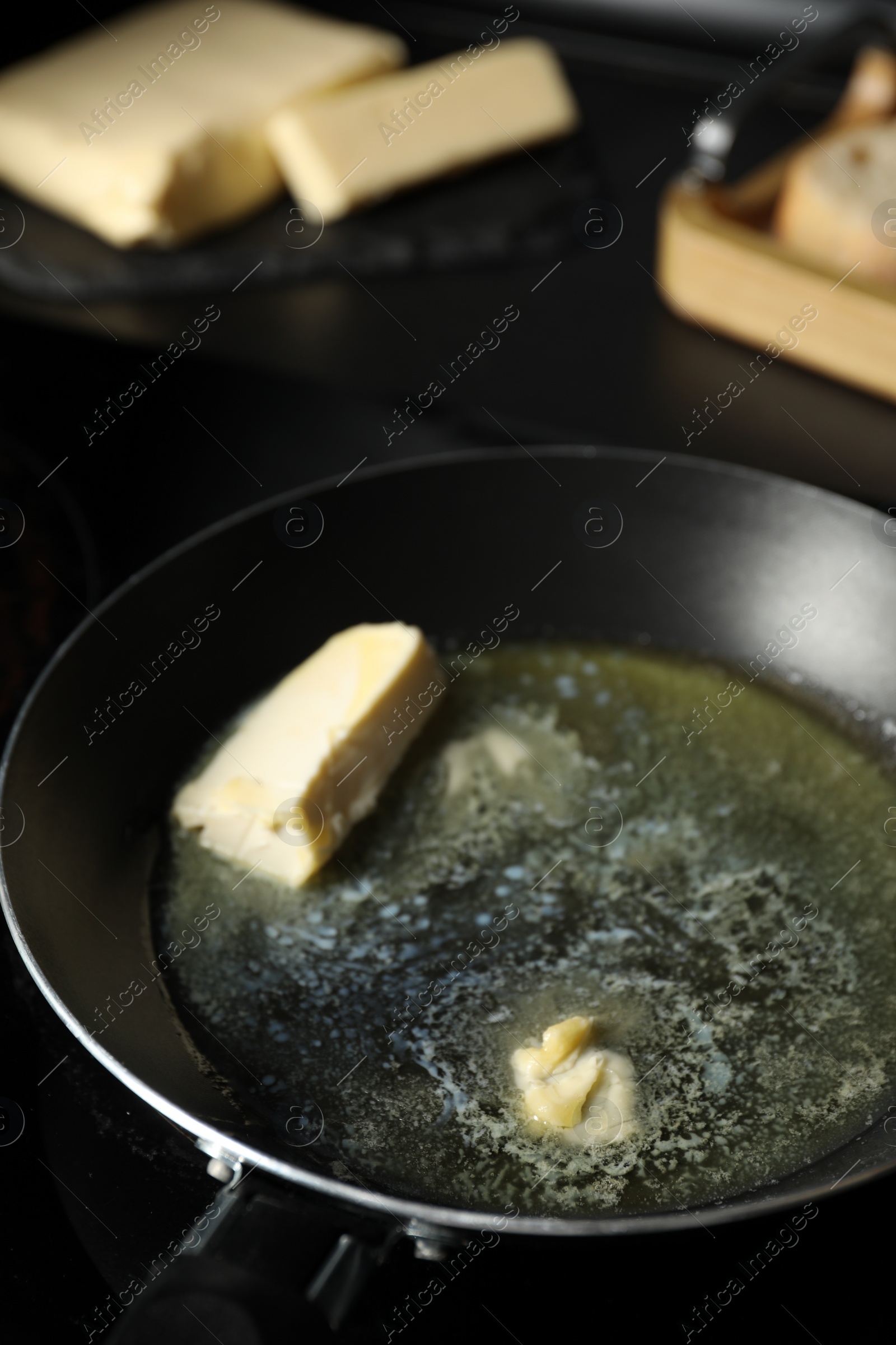 Photo of Melting butter in frying pan on table