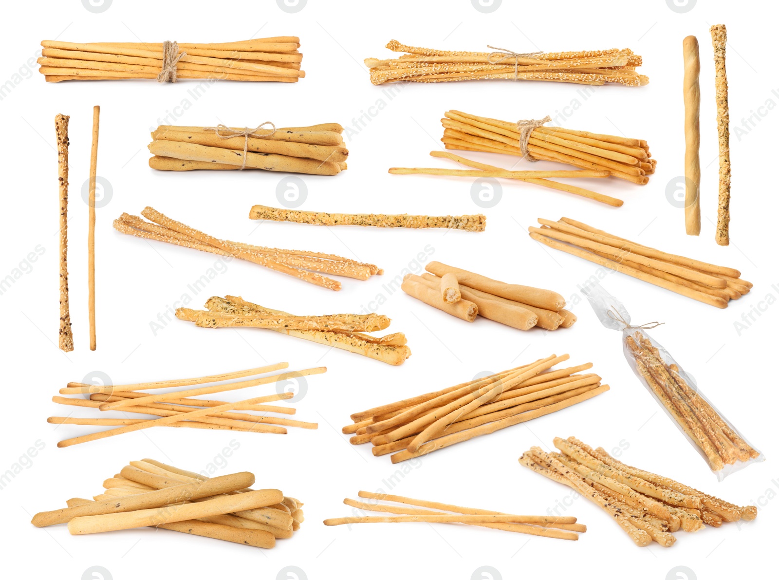 Image of Set with delicious crispy grissini sticks on white background