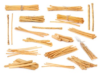 Set with delicious crispy grissini sticks on white background