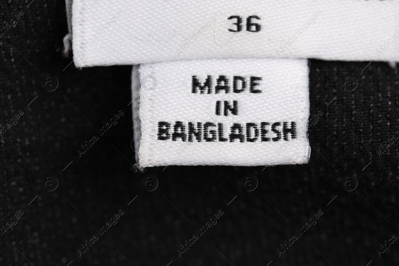 Photo of Clothing labels on black garment, top view