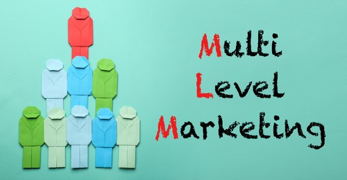 Multi-level marketing. Pyramid of paper human figures with red one at top showing hierarchy on turquoise background, flat lay