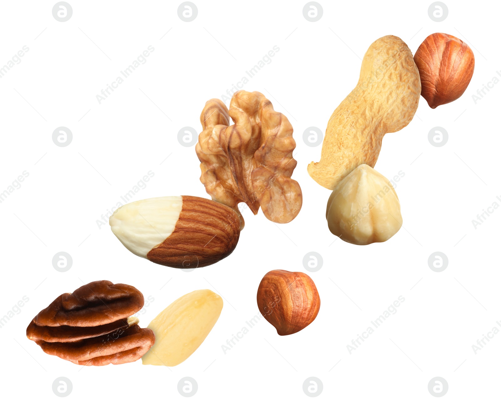 Image of Many different nuts in air on white background