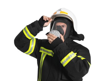 Photo of Portrait of firefighter in uniform, helmet and gas mask on white background