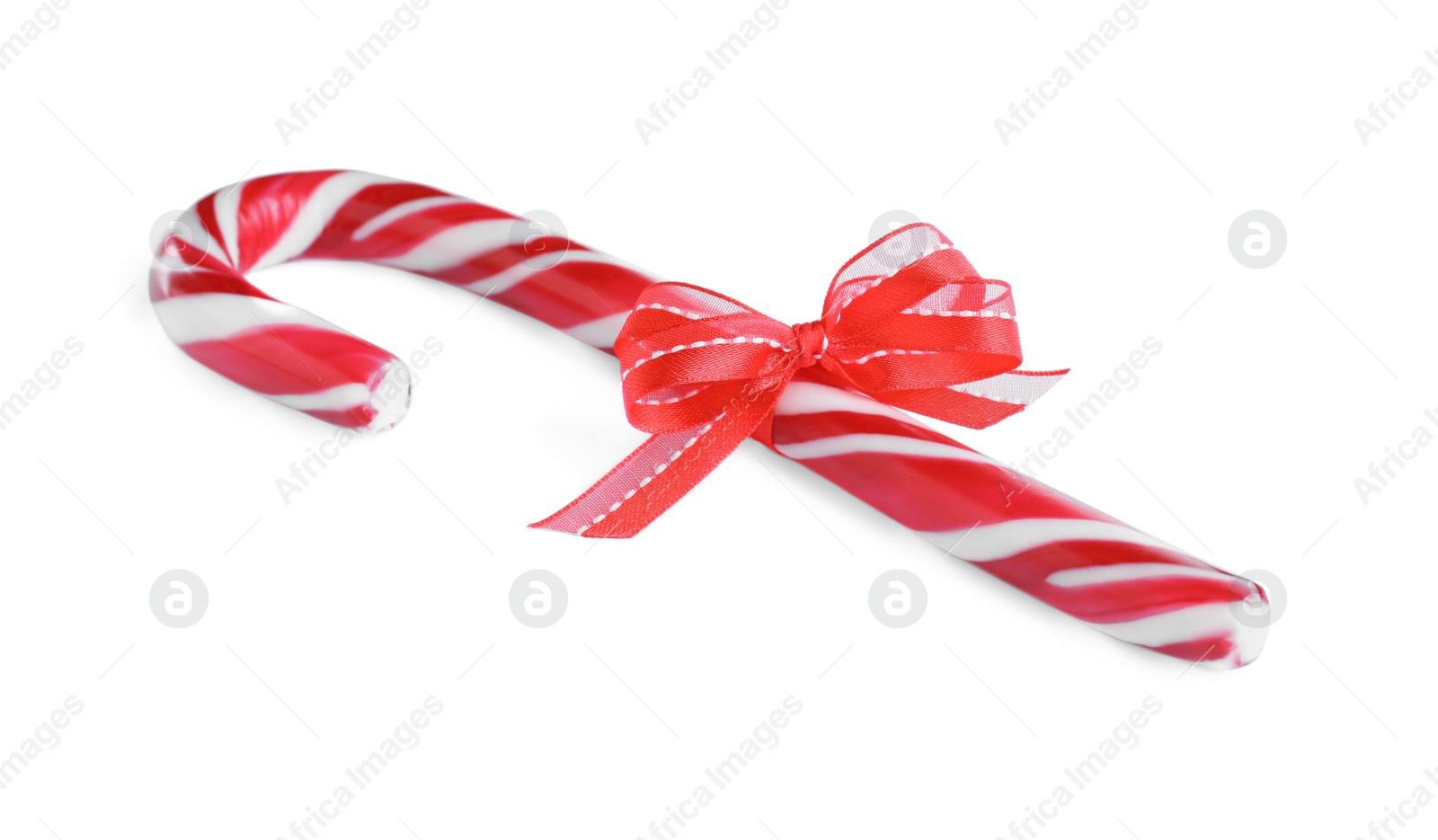 Photo of Sweet Christmas candy cane with red bow isolated on white