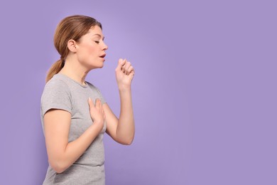 Photo of Woman coughing on violet background, space for text. Sore throat