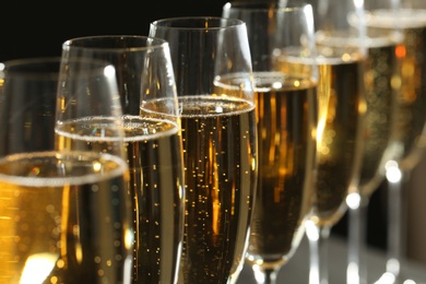 Glasses of champagne on dark background, closeup