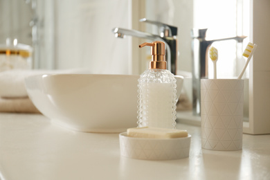 Toiletries near vessel sink in modern bathroom